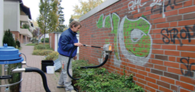 Professional removal of graffiti from a brick wall - Before